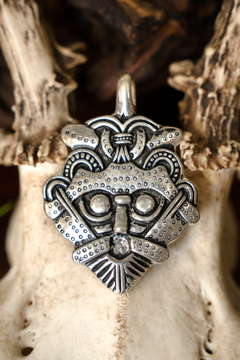 Gnezdovo mask amulet, silvered bronze