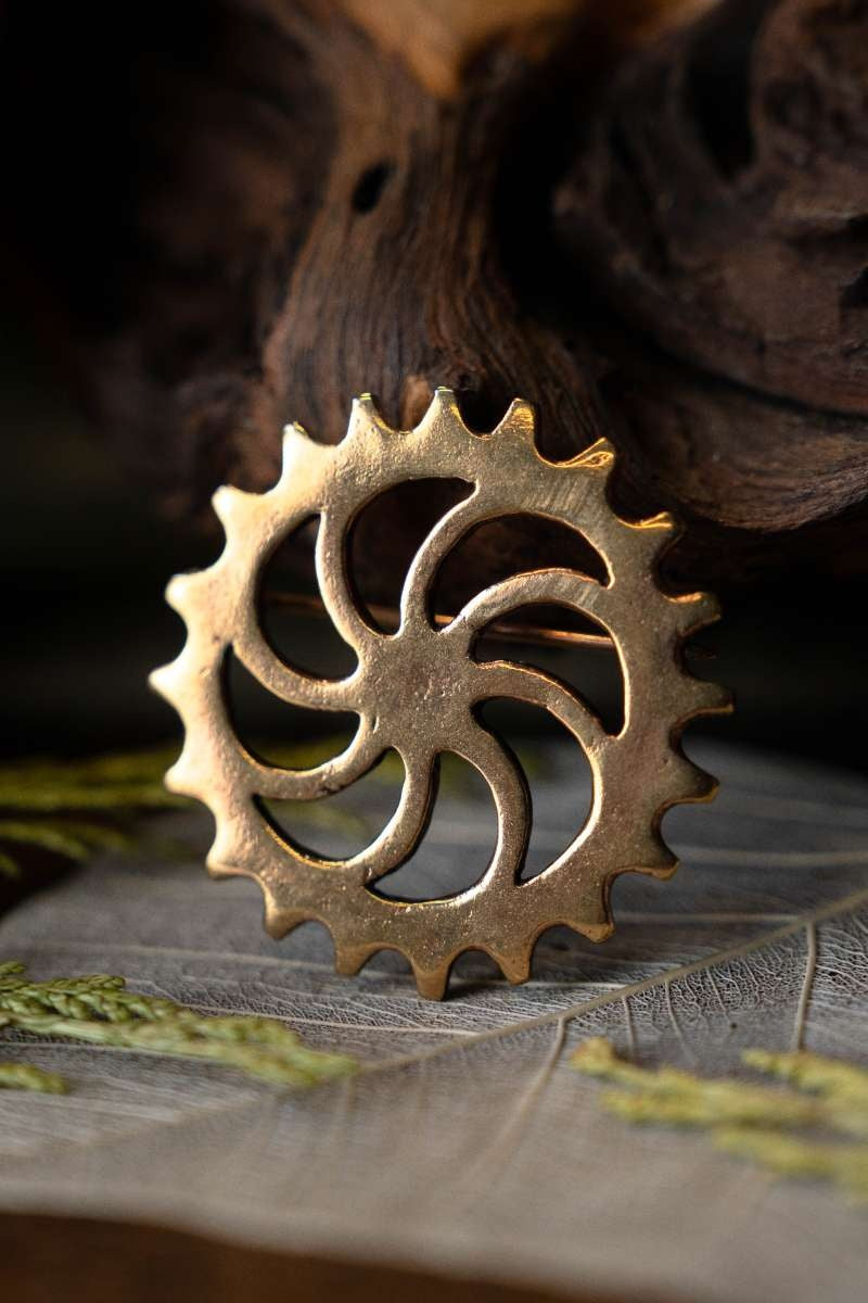 Fibule à disque romaine roue solaire, bronze