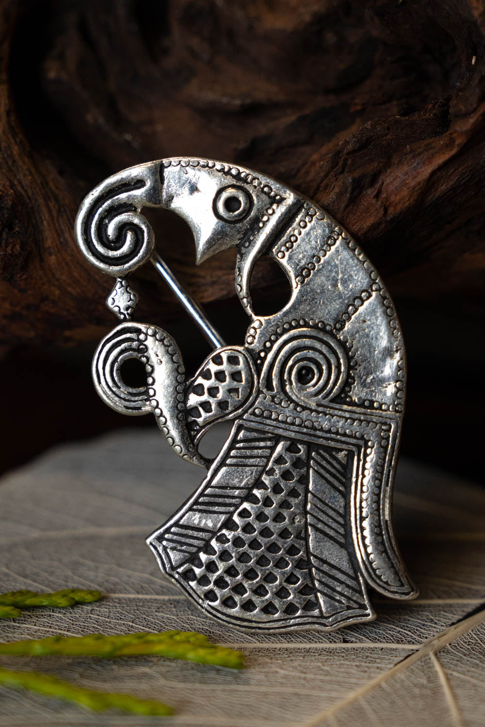 Germanic raven brooch Gotland, left, silvered bronze