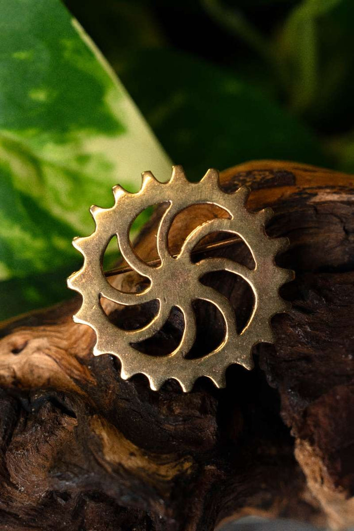 Fibule à disque romaine roue solaire, bronze
