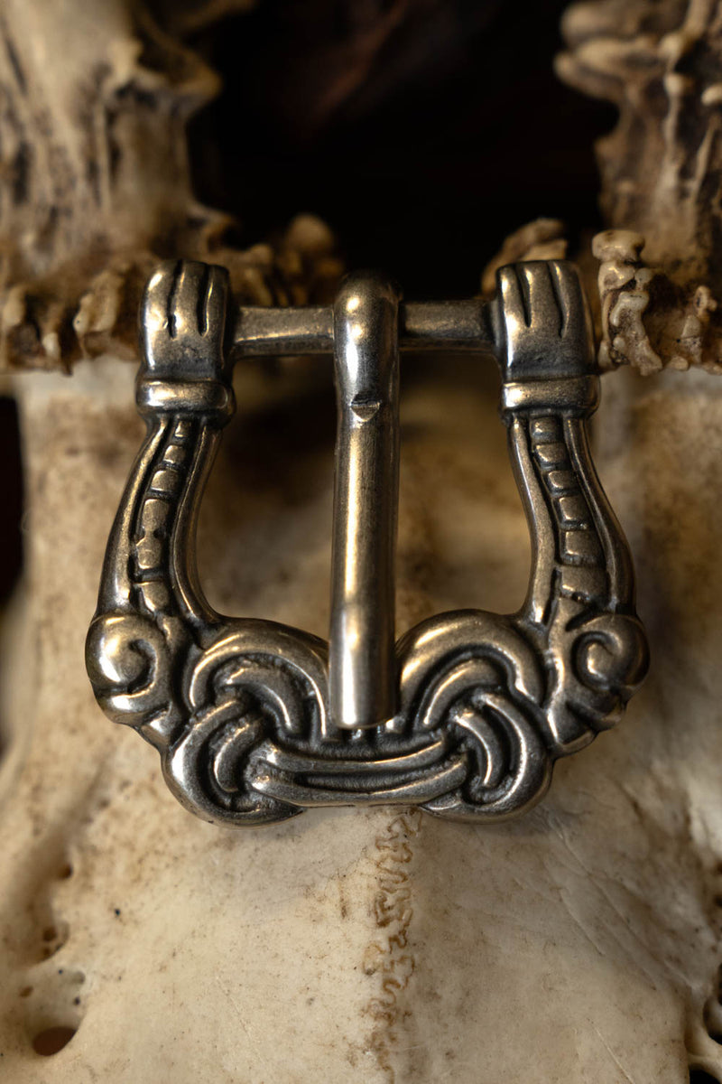 Viking buckle gripping hands, silvered
