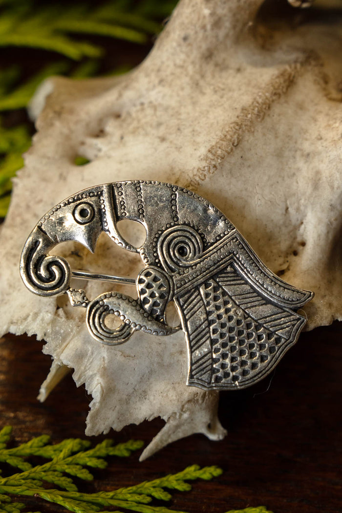 Germanic raven brooch Gotland, left, silvered bronze